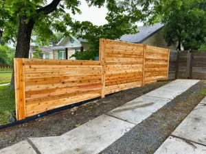 Installed slatted wood privacy fence with sleek design