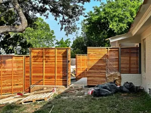 Repaired wood fence with fresh finish